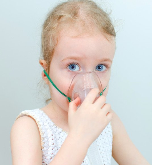 Portrait of little girl with inhalator mask on the face